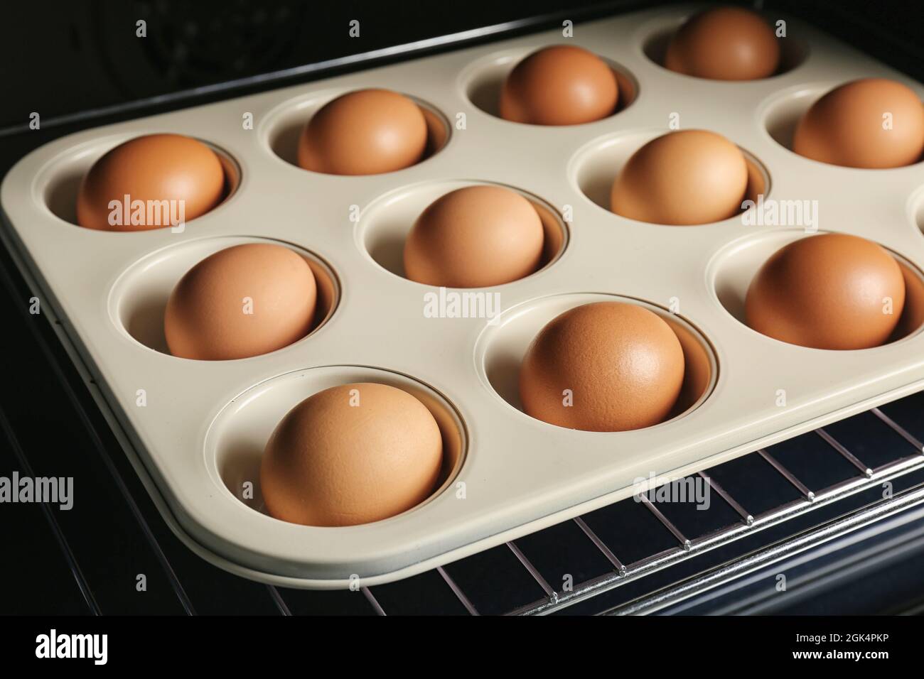 Muffin tin with hard boiled eggs in oven, closeup Stock Photo Alamy