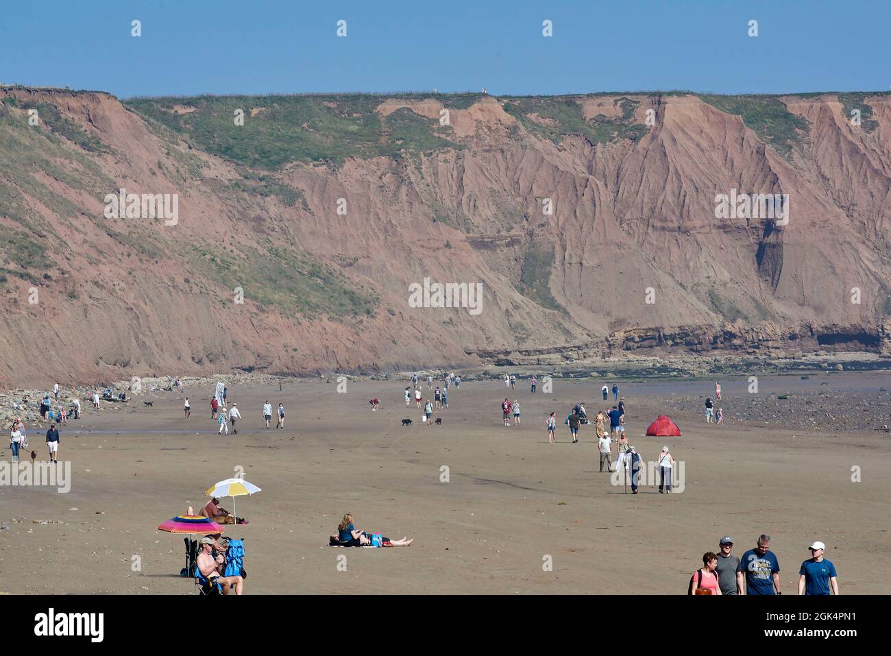 People sunbathing on Filey Beach, North Yorkshire east coast, busy with holiday makers, Northern England, UK Stock Photo