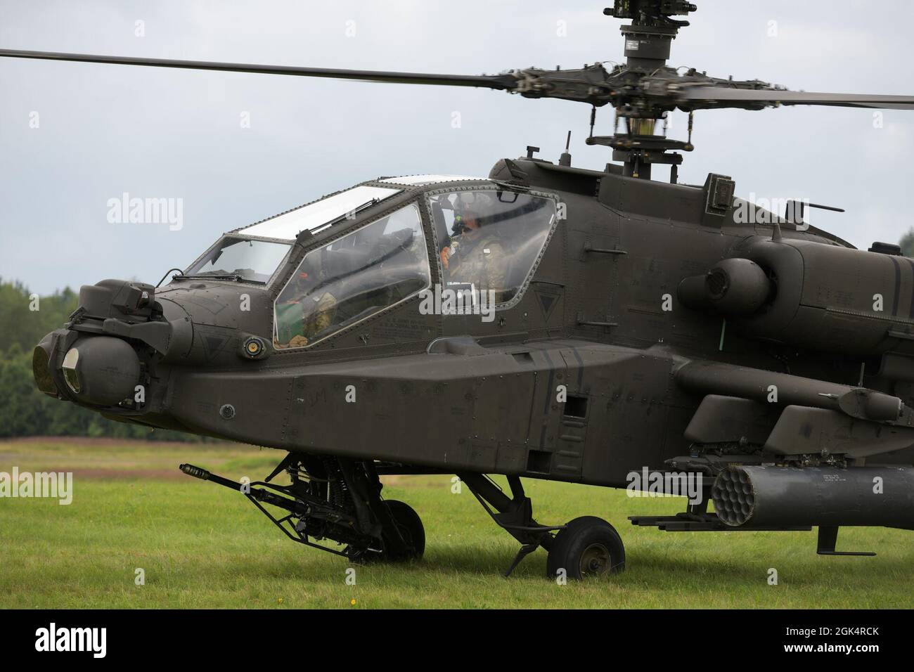 U.S. Soldiers, assigned to 1st Combat Aviation Brigade, 1st Infantry Division, perform system readiness checks on a AH-64D Apache Longbow attack helicopter prior to taking off during aerial gunnery training at the 7th Army Training Command's Grafenwoehr Training Area, Germany, Aug. 4, 2021. Stock Photo