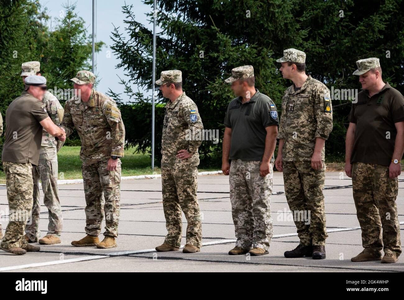 Ukrainian Air Force and Ukrainian Special Operations Command members welcome Airmen of the 352d Special Operations Wing during an opening ceremony beginning a month of interoperability training events in Vinnytsia, Ukraine, August 2, 2021. The 352d SOW deployed to Ukraine to demonstrate commitment in the Black Sea region by strengthening relationships and combined capability. Stock Photo