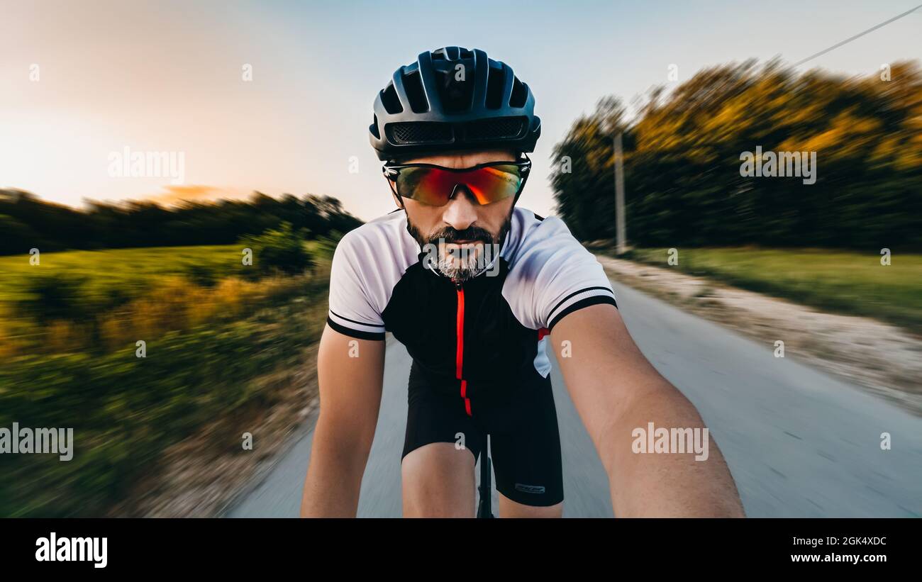 Closeup shot of a bicycle rider on the road making a selfie during the riding Stock Photo Alamy