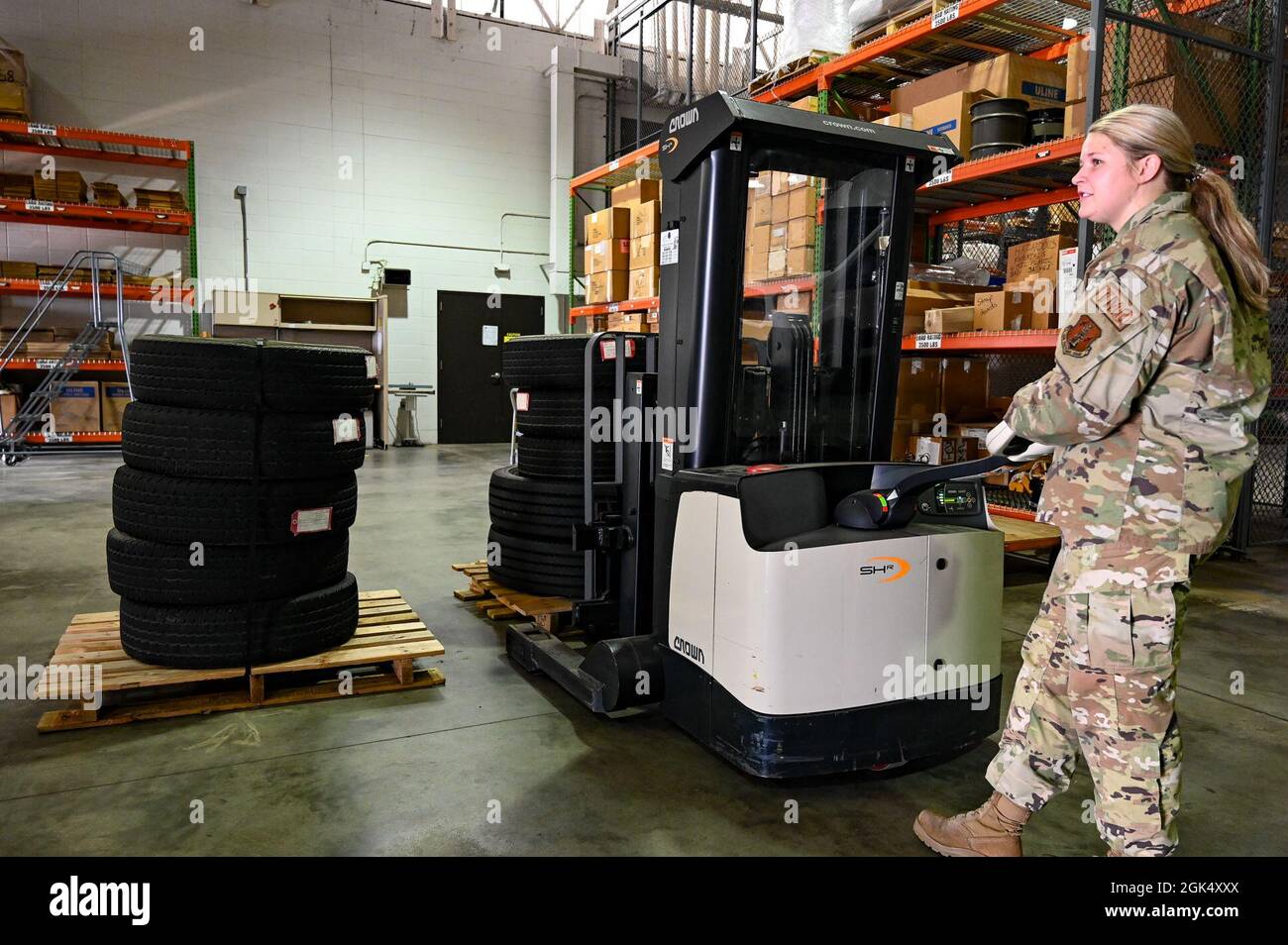 Senior Airman Sadie Vandersteen, 114th Logistics Readiness Squadron Traffic Management Office (TMO) specialist, operates a heavy duty Walkie Stacker while organizing shipments in the TMO warehouse at Joe Foss Field, S.D., Aug 2, 2021. The TMO is responsible for processing and managing cargo, as well as receiving supplies for the base, ensuring the South Dakota Air National Guard can fulfill its mission both in state and around the world. Stock Photo
