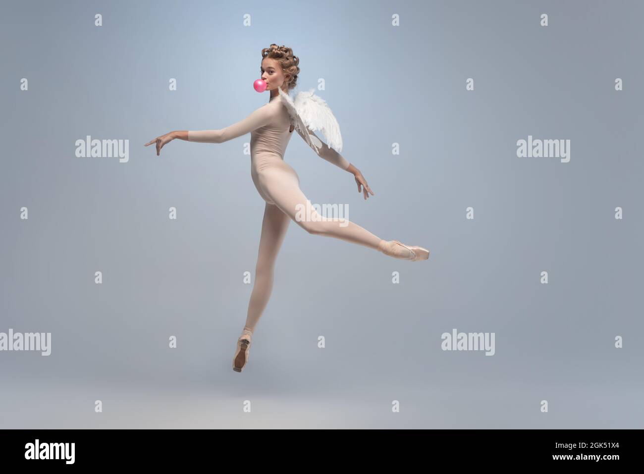 Full-length of graceful ballerina dancing in image of angel with wings isolated on gray studio Art, motion, action Stock Photo - Alamy