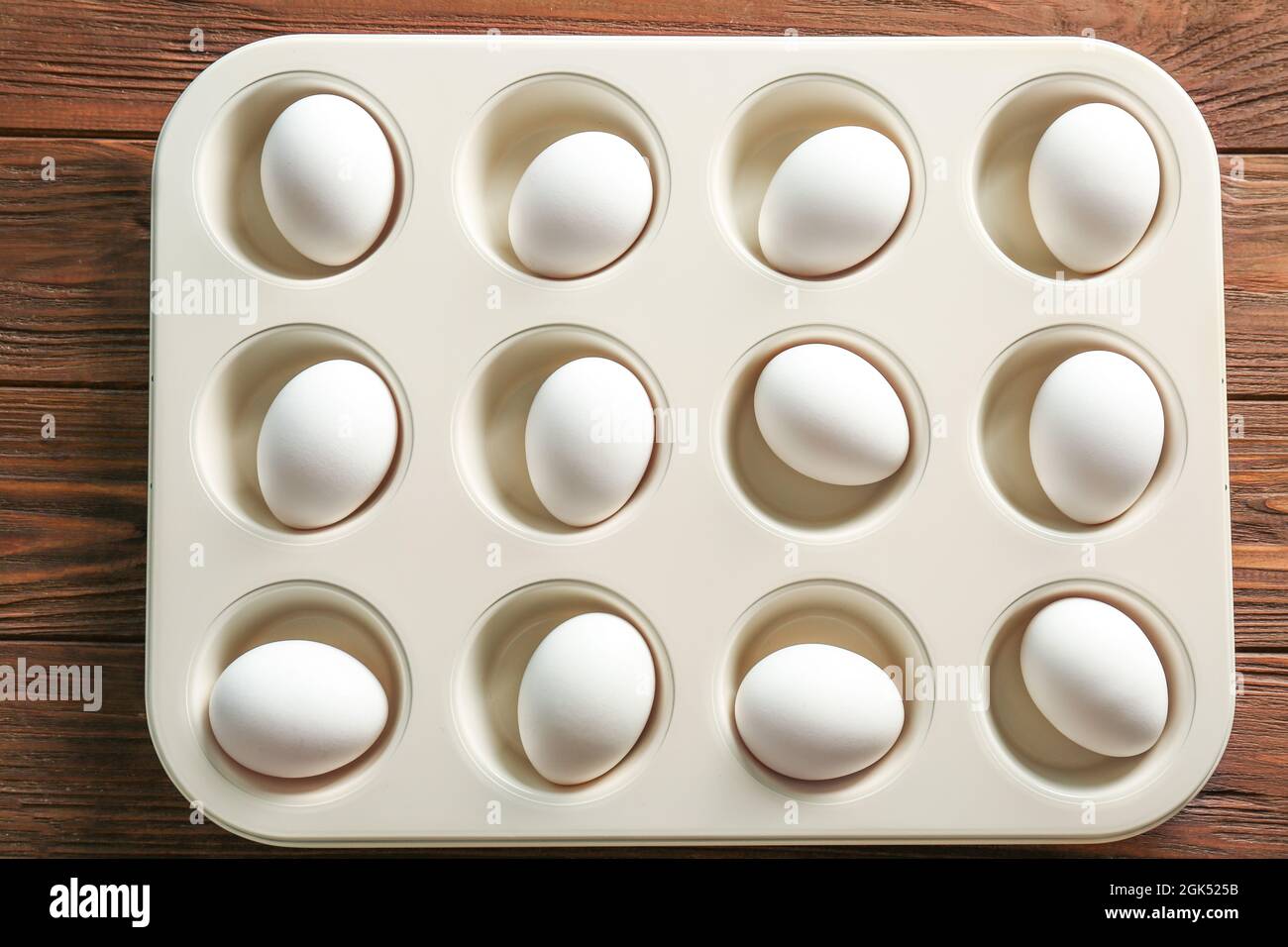 Hard boiled eggs in muffin tin on table Stock Photo Alamy