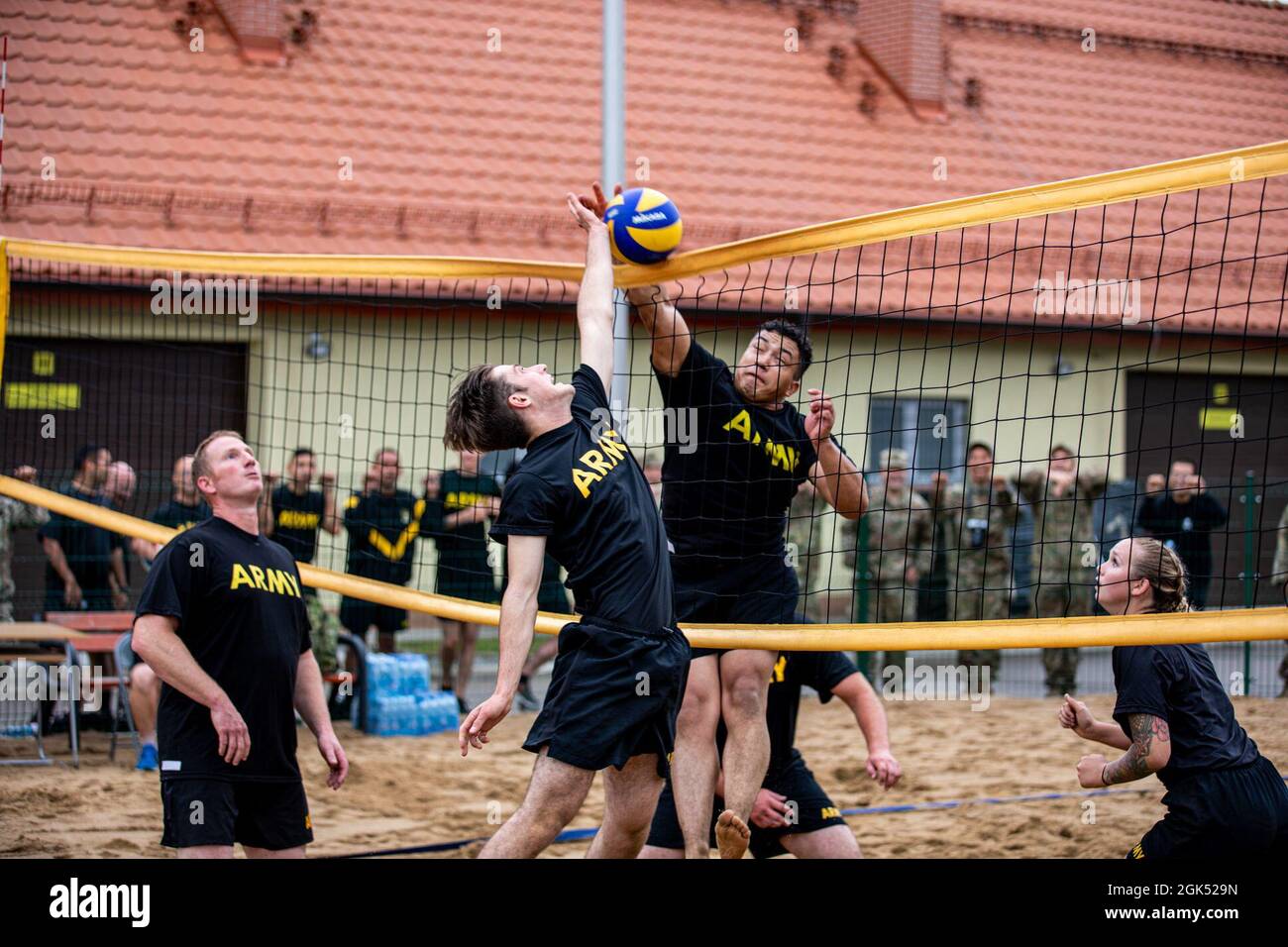 U.S. Army Soldiers from 3rd Battalion, 161st Infantry Regiment, play volleyball during a sports day celebrating Croatia’s Day of Victory at Bemowo Piskie Training Area, Poland, August 4, 2021. Battle Group Poland celebrated Croatian Day of Victory and Homeland Gratitude and also joined Croatians in celebrating the Day of Croatian War Veterans at Bemowo Piskie Training Area, August 4-5, 2021. US and Romanian soldiers joined Croatians for a football, volleyball and bocce tournament building the battle group’s unity and partnership. Stock Photo
