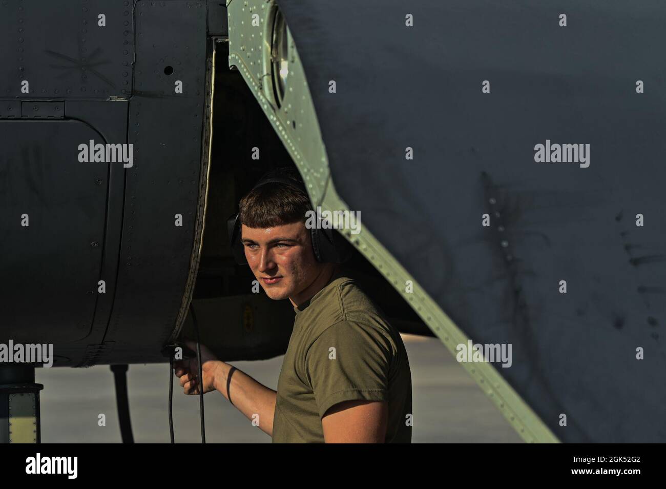 Airman 1st Class Shane Davis looks out from underneath a B-52H Stratofortress during Red Flag-Nellis 21-3 at Nellis Air Force Base, Nevada, Aug. 2, 2021. Aircraft maintenance Airmen stationed at Nellis are the most important component of readiness to help train, instruct and lead our Airmen and partners to win any fight. Stock Photo