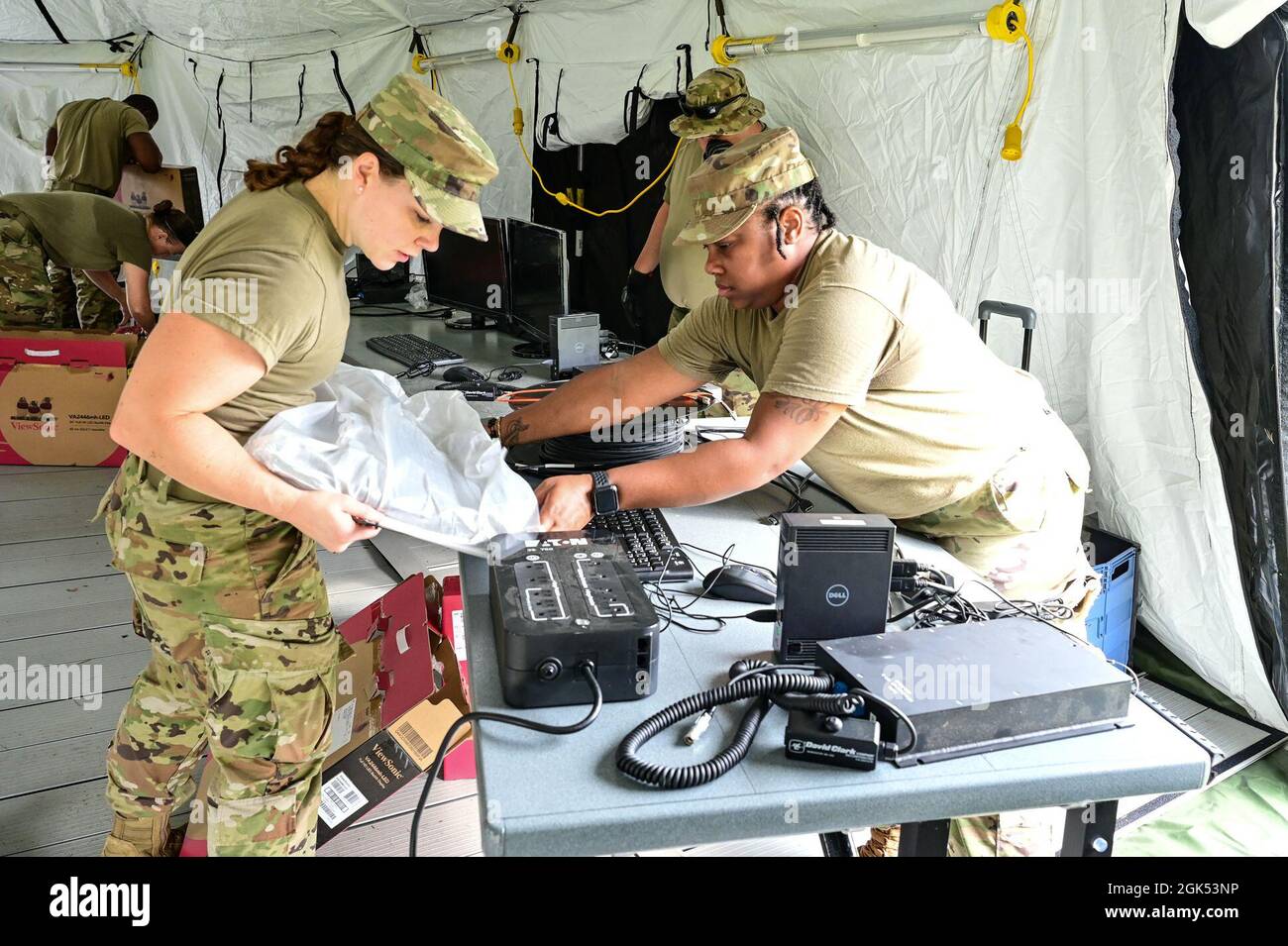 U.S. Air Force Airman 1st Class Emily Kerwin, Cybersureity and Staff Sgt. De’Lisha Brooks, Client Systems Technician from the 117th Air Control Squadron, Georgia Air National Guard setup computer systems for a mobile command and control facility during their two weeks of annual field training at Fernandino Beach, Florida, August 3, 2021. The 117th Air Control Squadron provides theater command with air battle management, radar surveillance, air space control, and long haul communication capabilities to plan and execute combined air operations; air superiority and air strike ground attack operat Stock Photo