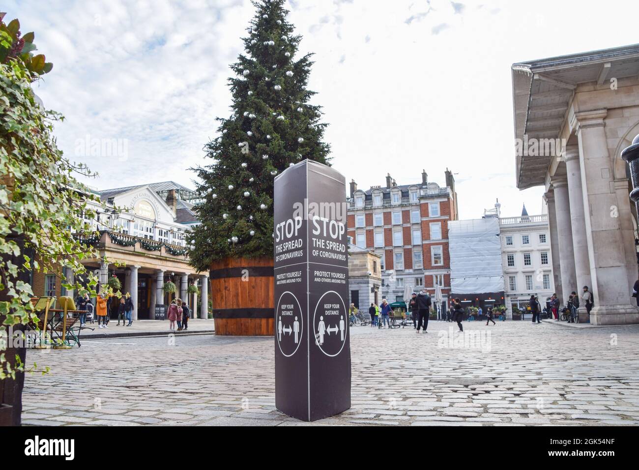 'Stop The Spread Of Coronavirus' sign next to the Christmas tree in Covent Garden. London, United Kingdom 22 November 2020. Stock Photo
