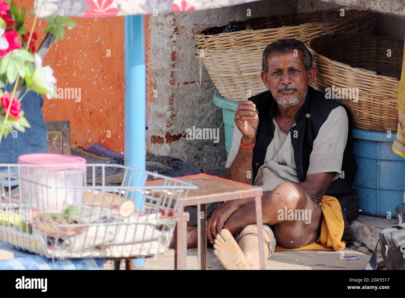 Orchha, Madhya Pradesh, India - March 2019: An Indian male street vendor sitting alone idle in his roadside stall. Stock Photo