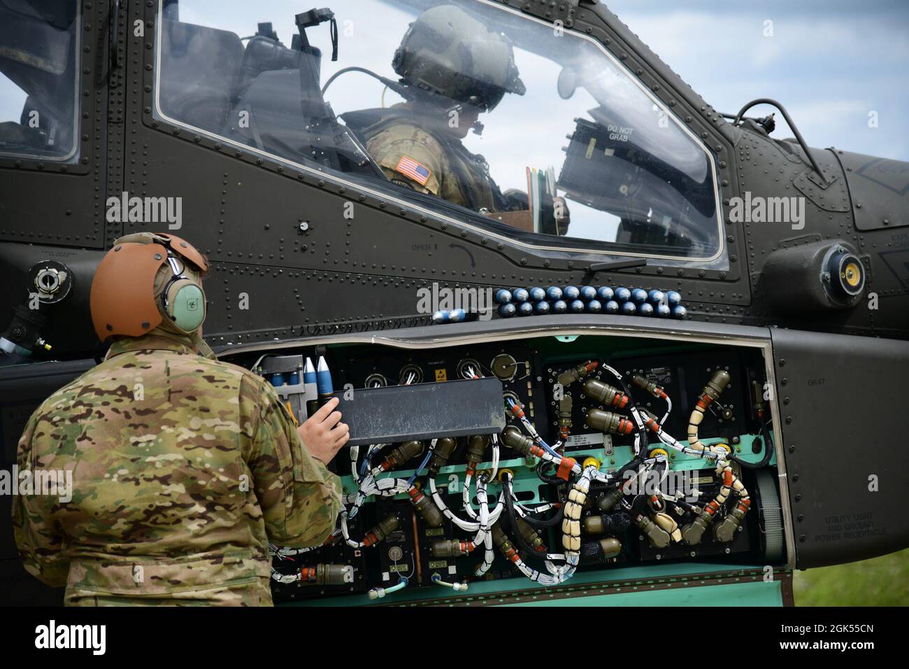U.S. Soldiers, assigned to 1st Combat Aviation Brigade, 1st Infantry Division, conduct aerial gunnery training flying in a AH-64D Apache Longbow attack helicopter at the 7th Army Training Command's Grafenwoehr Training Area, Germany, Aug. 4, 2021. Stock Photo