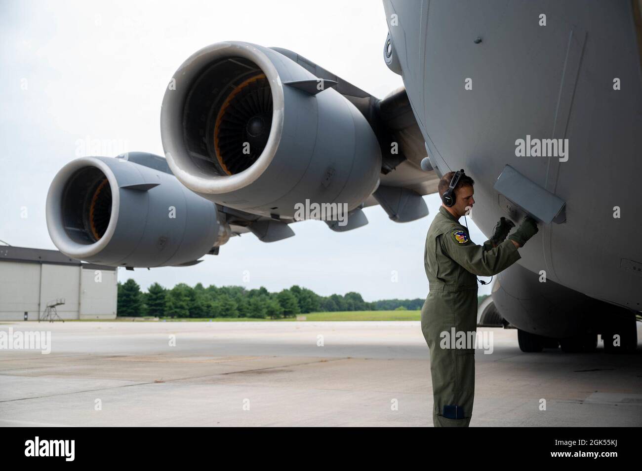 Maj. Daniel Velo, 3rd Airlift Squadron pilot, closes an external power  outlet on a C-17 Globemaster III before a local training flight at Dover  Air Force Base, Delaware, Aug. 4, 2021. The
