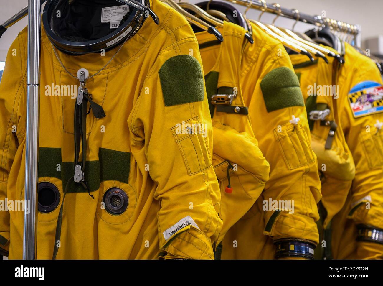 9th Physiological Support Squadron full-pressure suits hang on racks Aug. 4, 2021, at Beale Air Force Base, California. The full-pressure suits are specifically worn by U-2 Dragon Lady pilots because the aircraft can fly at such high altitudes  that in case of loss of cabin pressure, the pilots stay safe. Stock Photo