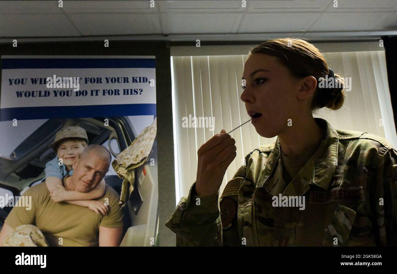 U.S. Air Force Capt. Bethany Young, 325th Medical Group clinical psychologist, swabs her inner