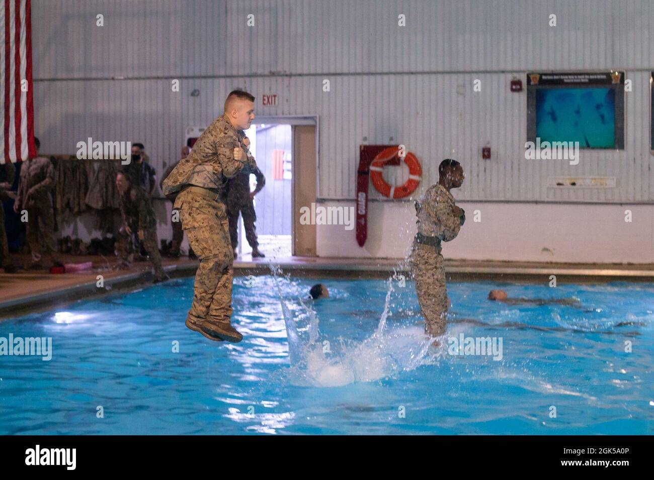 U.S. Marine Corps Officers assigned to The Basic School, conduct Intermediate Swim Qualification on Marine Corps Base Quantico, Virginia, Aug. 6, 2021. Intermediate Swim Qualification is designed to instill the self-confidence needed to overcome mental and physical adversity that could arise during actual combat water survival scenarios. Stock Photo