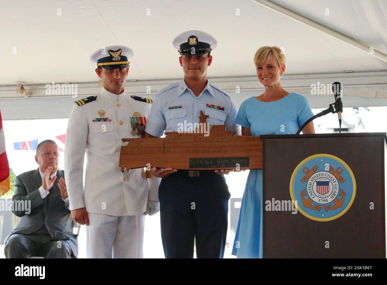 Lt. Reginald Reynolds, commanding officer of the Coast Guard Cutter Glen Harris, Petty Officer Third Class Kendrick Aguilar and Ms. Stacy Howley, the vessel's sponsor, pose for a photo during the vessel's commissioning ceremony at Coast Guard Sector Field Office Fort Macon in Beaufort, North Carolina, Aug. 6, 2021. The cutter's namesake, Chief Petty Officer Glen Livingston Harris, acted as a landing craft coxswain during the landing of Tulagi, Aug. 7-9, 1942, during World War II. Along with three other U.S. Coast Guard coxswains, Harris landed the first U.S. Marines on Tulagi and, over the nex Stock Photo