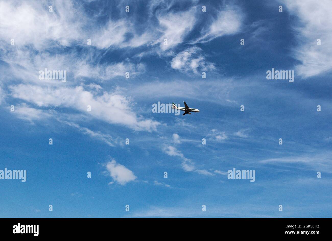 Airplane of Alitalia Airways flying through sky prepare to landing Stock Photo