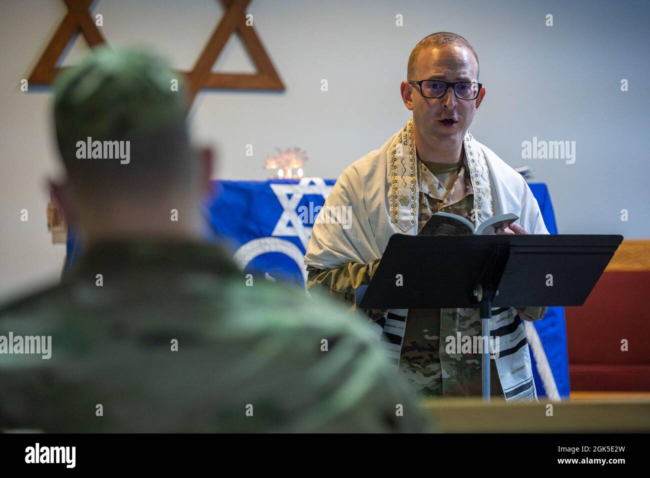U.S. Air Force Chaplain Capt. Saul Rappeport, rabbi, 380th Air Expeditionary Wing, reads from the military edition Siddur prayer book at Al Dhafra Air Base, United Arab Emirates, Aug 6, 2021. ADAB’s unique chapel team is comprised of three different religious leaders and offers Jewish, Catholic and Protestant services and events throughout the week. Stock Photo