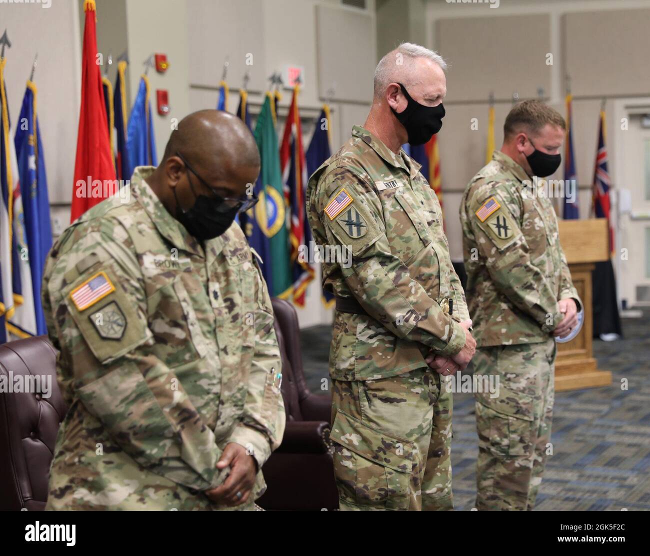 U.S. Army Brigadier General John Gentry, commander of the Marietta-based 78th Troop Command, Lt. Col. Pervis Brown, the outgoing commander of the Marietta-based 781st Troop Command Battalion, and Maj. Aaron Holt, the incoming commander of the 781st Troop Command Battalion, pray during a change of command ceremony at Clay National Guard Center Marietta, Georgia, on August 7, 2021. Invocation is a traditional part of a change of command ceremony. Stock Photo