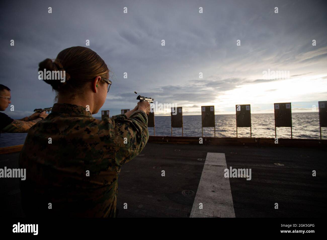 U.S. Marine Corps 1st Lt. Elizabeth Schilder, a weapons and tactics  instructor, with 31st Marine Expeditionary Unit (MEU), waits for further  instruction during a shooting competition aboard amphibious assault ship  USS America (
