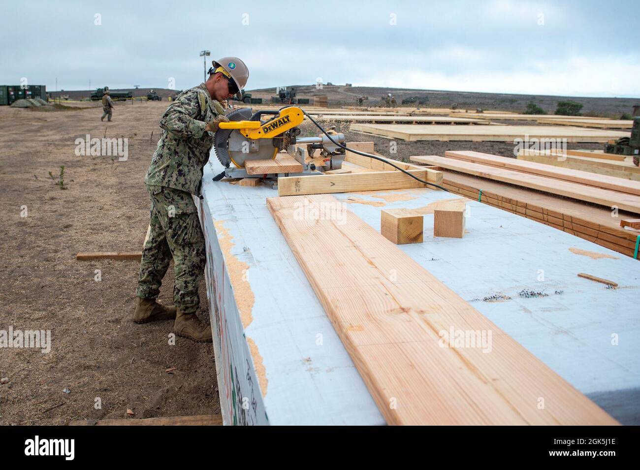 210808-N-TP832-1041 SAN CLEMENTE ISLAND, Calif. (Aug. 8, 2021) Builder Constructionman Cameron Boyd, assigned to U.S. Naval Mobile Construction Battalion 3, cuts mud sills for tent decks for construction and support of Expeditionary Advanced Base and Advanced Naval Base Operations as part of Exercise TURNING POINT. TURNING POINT is a major combat operations readiness generation exercise for the Pacific Naval Construction Force designed to support and enable fleet maneuver and logistics. Stock Photo