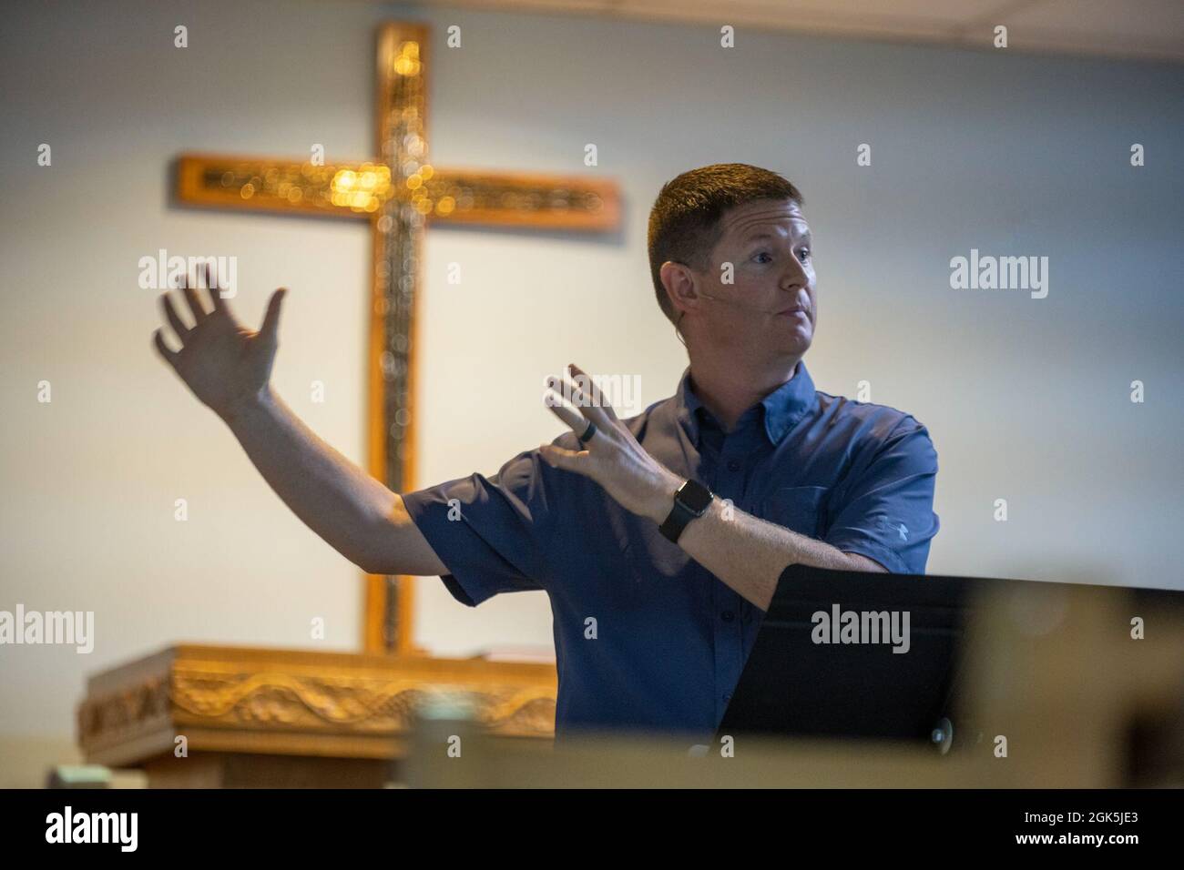 U.S. Air Force Chaplain Capt. Paul Walker, pastor, 380th Air Expeditionary  Wing, reads from the Holy Bible during a Protestant service at Al Dhafra  Air Base, United Arab Emirates, Aug 8, 2021.
