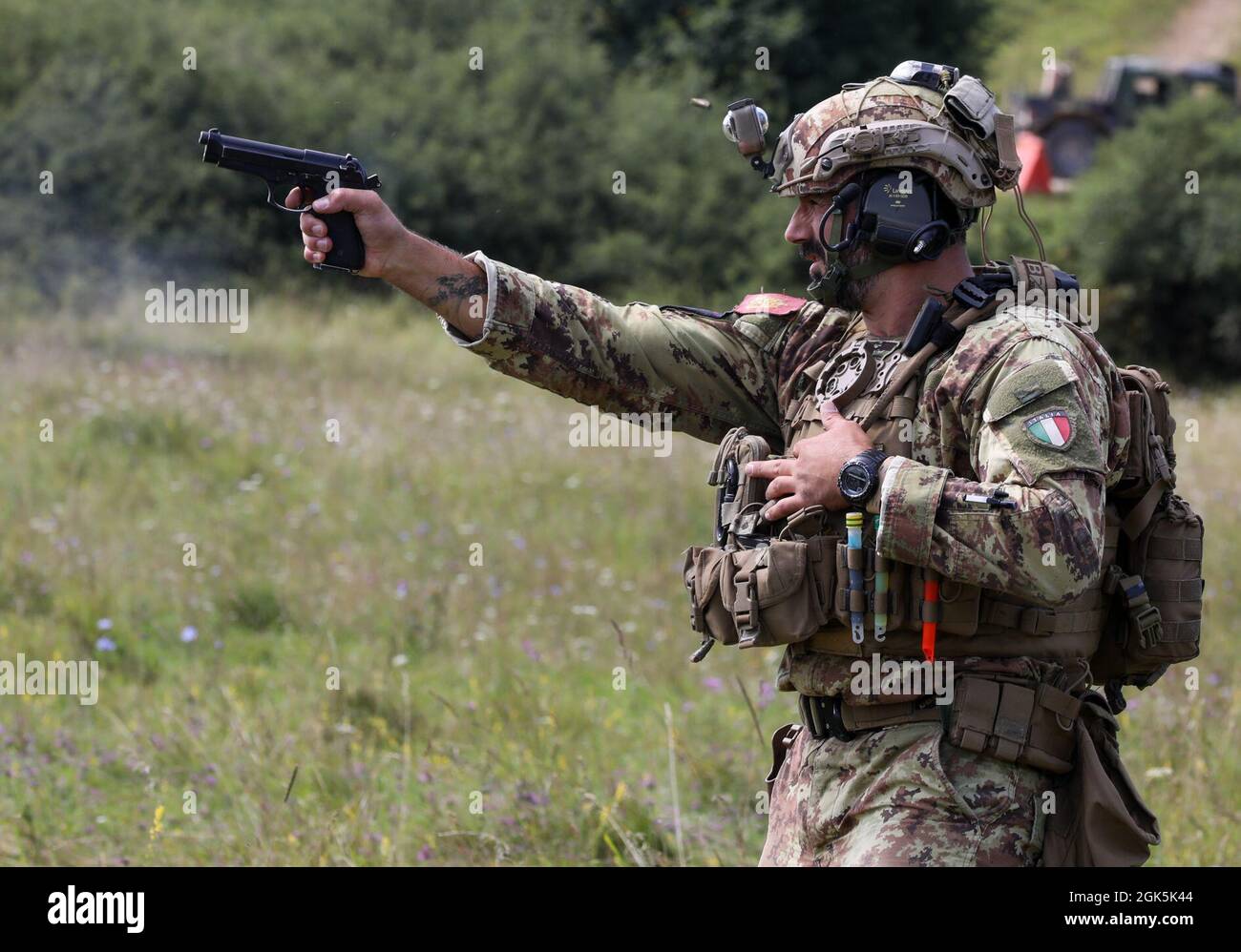 An Italian sniper competitor fires his pistol at paper targets during the Mogadishu event on Hohenfels Training Area Germany, Aug. 9, 2021. The 2021 European Best Sniper Team Competition is a U.S. Army Europe and Africa-directed, 7th Army Training Command hosted contest of skill that includes 14 participating NATO allies and partner nations at 7th ATC’s Hohenfels Training Area, Aug 8-14. Stock Photo