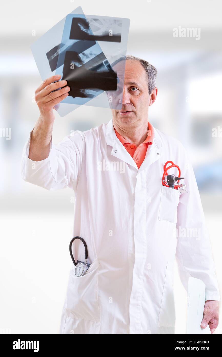Doctor examining xray against blurry background Stock Photo Alamy