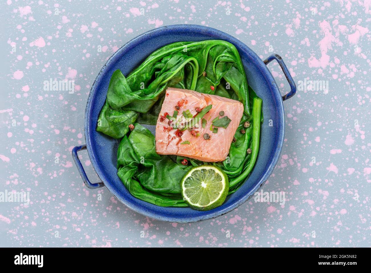 Grilled salmon with spinach, lemon and thyme. Stock Photo