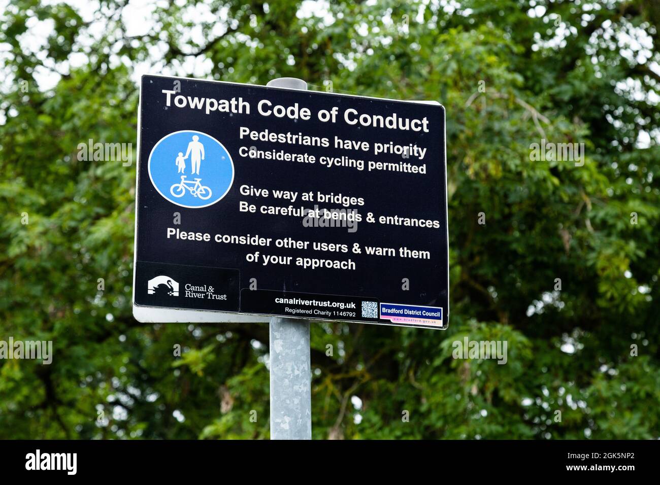 A Towpath Code of Conduct sign on the towpath of the Leeds Liverpool Canal at Bingley, West Yorkshire, England. Stock Photo