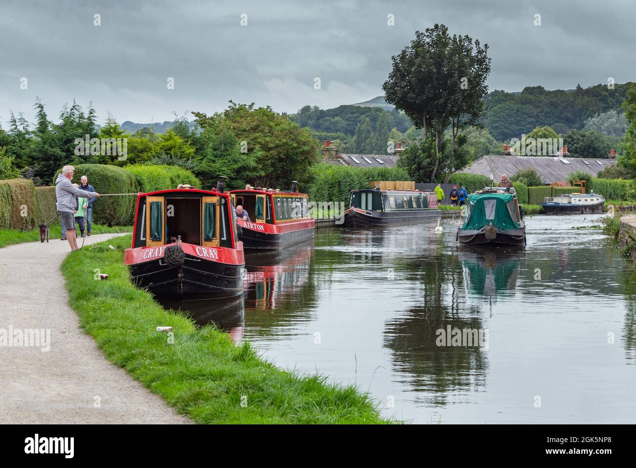 Barges (flat bottomed boats/narrowboats) on the Leeds Liverpool Canal at Micklethwaite, near Bingley, West Yorkshire. Stock Photo
