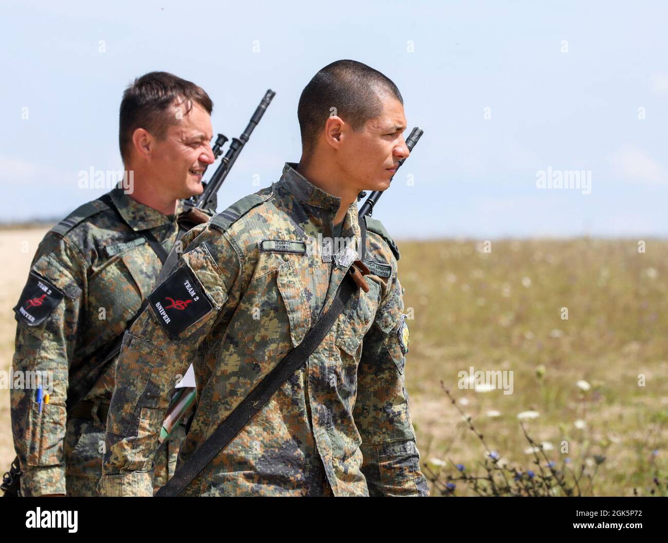 Dimitar Dimirev and Nikolay Atanasov, A Bulgarian sniper team look out in the distance during the range estimation event of the European Best Sniper Team Competition, on Hohenfels, Germany, Aug. 10, 2021. The 2021 European Best Sniper Team Competition is a U.S. Army Europe and Africa-directed, 7th Army Training Command hosted contest of skill that includes 8 participating NATO allies and partner nations at 7th ATC’s Hohenfels Training Area, August 8-14. The European Best Sniper Team Competition is designed to improve professionalism and enhance esprit de corps. Stock Photo