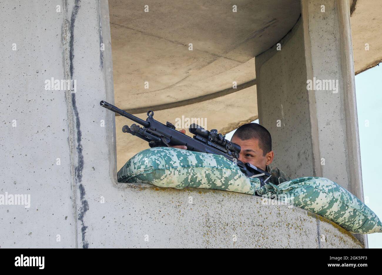 Dimitar Dimirev, A Bulgarian sniper looks through his scope during the range estimation event of the European Best Sniper Team Competition, on Hohenfels, Germany, Aug. 10, 2021. The 2021 European Best Sniper Team Competition is a U.S. Army Europe and Africa-directed, 7th Army Training Command hosted contest of skill that includes 8 participating NATO allies and partner nations at 7th ATC’s Hohenfels Training Area, August 8-14. The European Best Sniper Team Competition is designed to improve professionalism and enhance esprit de corps. Stock Photo