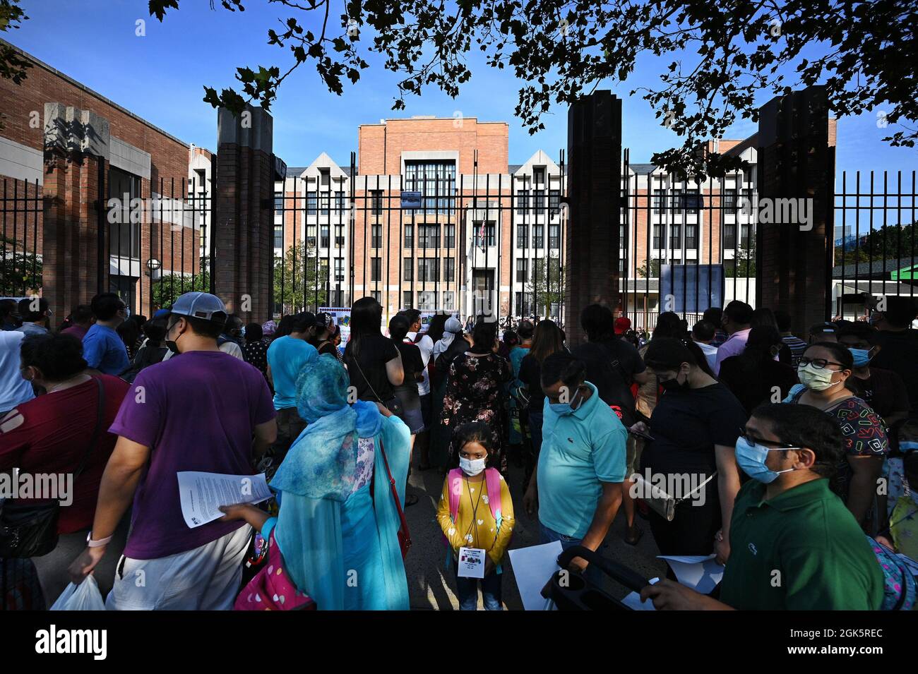 Families line up to drop off their children for inperson learning as