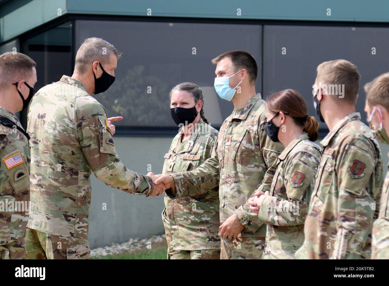 Army Gen. Daniel Hokanson, chief, National Guard Bureau, presents a coin to Airmen at Volk Field, Wis., Aug. 10, 2021. During his visit, Hokanson listened to Airmen about their challenges and successes, met with Wisconsin National Guard senior leaders, and observed Northern Lightning, an annual counterland training exercise that began Aug. 9 and will end Aug. 20. Wisconsin National Guard photo by Staff Sgt. Katie Theusch Stock Photo