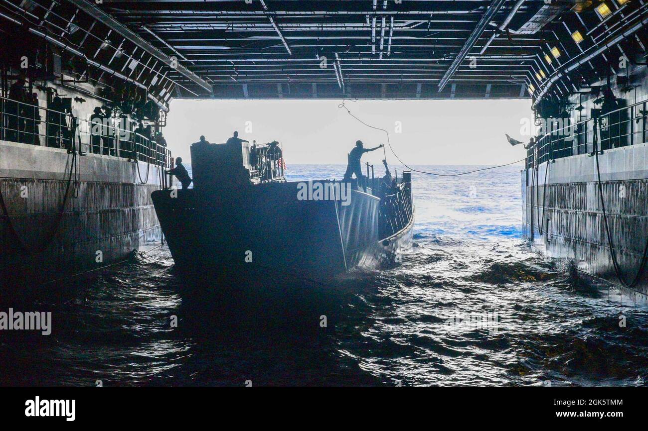 210810-N-MT581-1064    PACIFIC OCEAN (Aug. 10, 2021) Amphibious transport dock ship USS John P. Murtha (LPD 26) recovers a Landing Craft, Utility (LCU) assigned to Assault Craft Unit (ACU) 1 during exercise Freedom Banner 2021, Aug. 10. Freedom Banner is an annual exercise that involves strategic projection of the Maritime Prepositioning Force (MPF) and associated combat forces. This year’s iteration supports Large Scale Exercise (LSE) 2021, which is designed to refine how we synchronize maritime operation across multiple Fleets in support of the joint force. Stock Photo