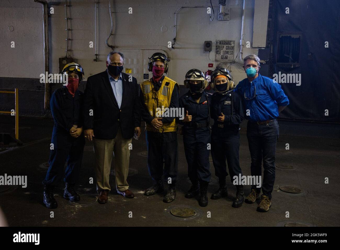 U.S. Secretary of the Navy Carlos Del Toro, and U.S. Representative Rob Wittman (R-VA), pose for a picture with Sailors aboard the USS Kearsarge during Large Scale Exercise (LSE) 2021, off the coast of North Carolina, Aug. 10, 2021. II MEF is a maritime force inextricably linked to our Navy partners in U.S. 6th and 2nd Fleets, creating mutual interdependence with our Fleet counterparts leverages our collective capabilities and increases maritime lethality. LSE 2021 merges live and synthetic training capabilities to create an intense, robust training environment. Stock Photo
