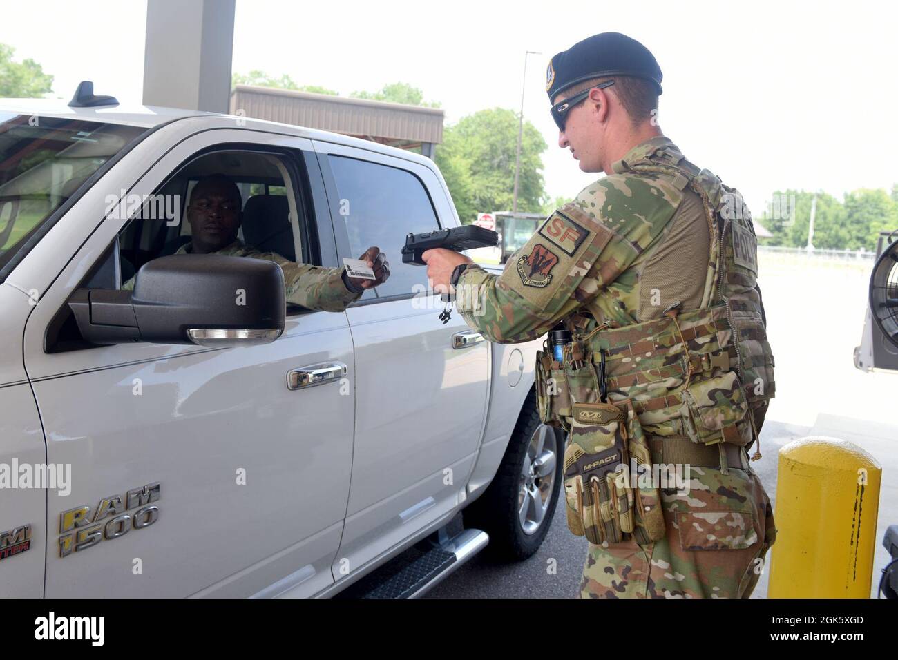 U.S. Air Force Airman 1st Class Banks Harmon, a 169th Security Forces Squadron installation controller, confirms identification of personnel entering the front gate at McEntire Joint National Guard Base, South Carolina, Aug. 10, 2021. Stock Photo