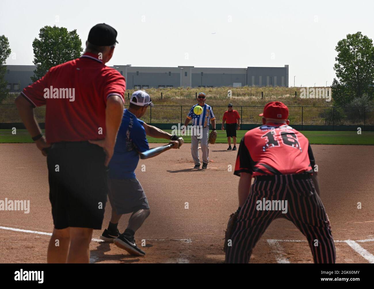 A member from the New Jersey Air National Guard pitches as a member from  the Wyoming National guard attempts to hit the ball at the Aurora Sports  Park, in Aurora, Colorado. Several