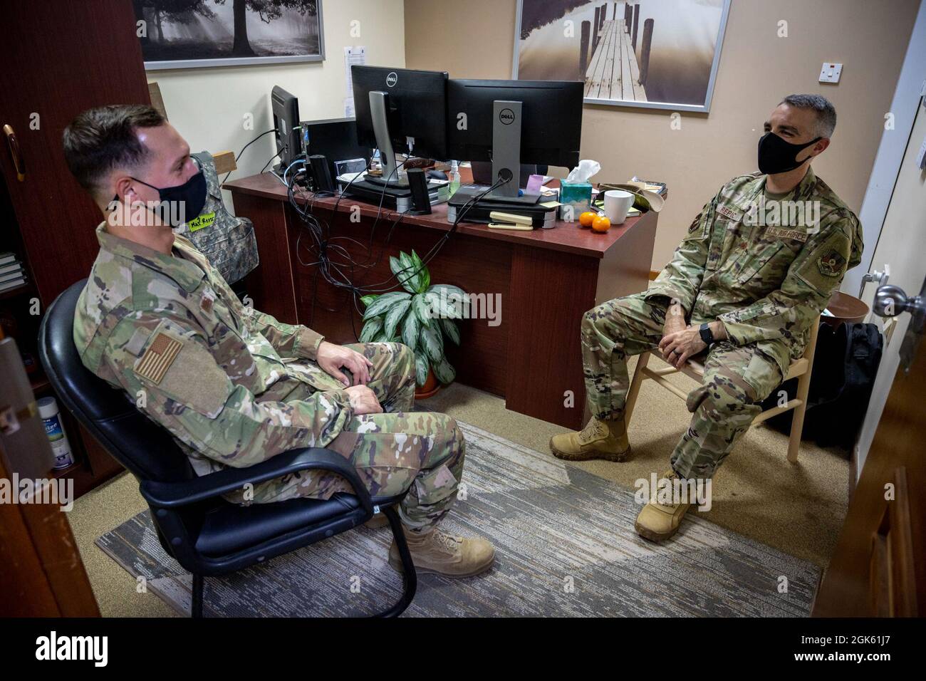 U.S. Air Force Chaplain Maj. Tony Repic, wing chaplain, 380th Air Expeditionary Wing, talks with Staff Sgt. Kyle Turner, 380 AEW, at Al Dhafra Air Base, United Arab Emirates, Aug 11, 2021. ADAB’s unique chapel team is comprised of three different religious leaders and offers Jewish, Catholic and Protestant services and events throughout the week. Stock Photo