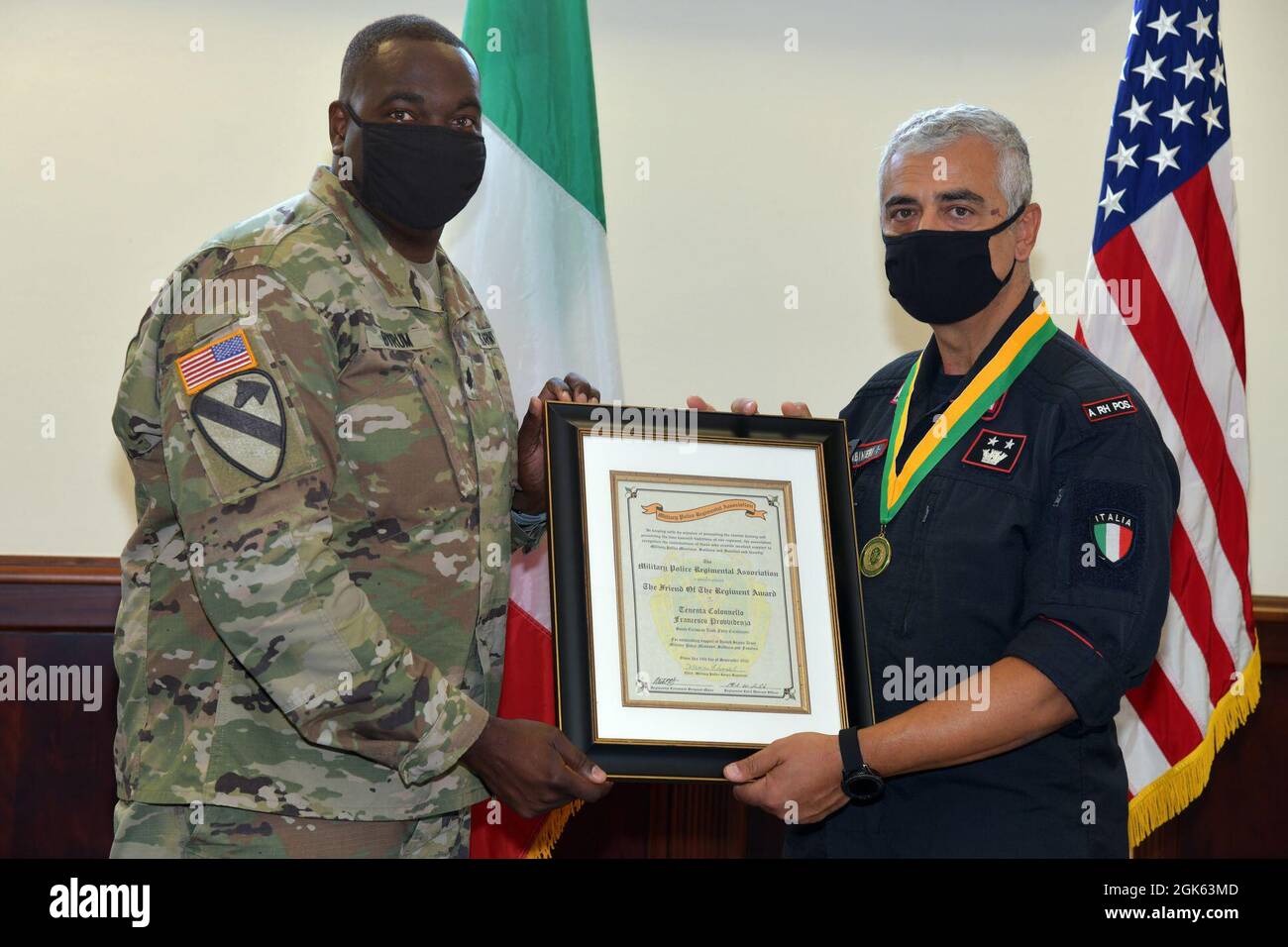 Lt. Col. Francesco Provvidenza, right, Company Commander of the Italian Army Carabinieri South European Task Force receives of the Military Police Regiment Association for the Friend of the Regiment Award from U.S. Army Lt. Col. Vaughan M. Byrum, left, Director of Emergency Services U.S. Army Garrison Italy, under Covid-19 prevention condition at Caserma Ederle, Vicenza, Italy August 12, 2021. Stock Photo