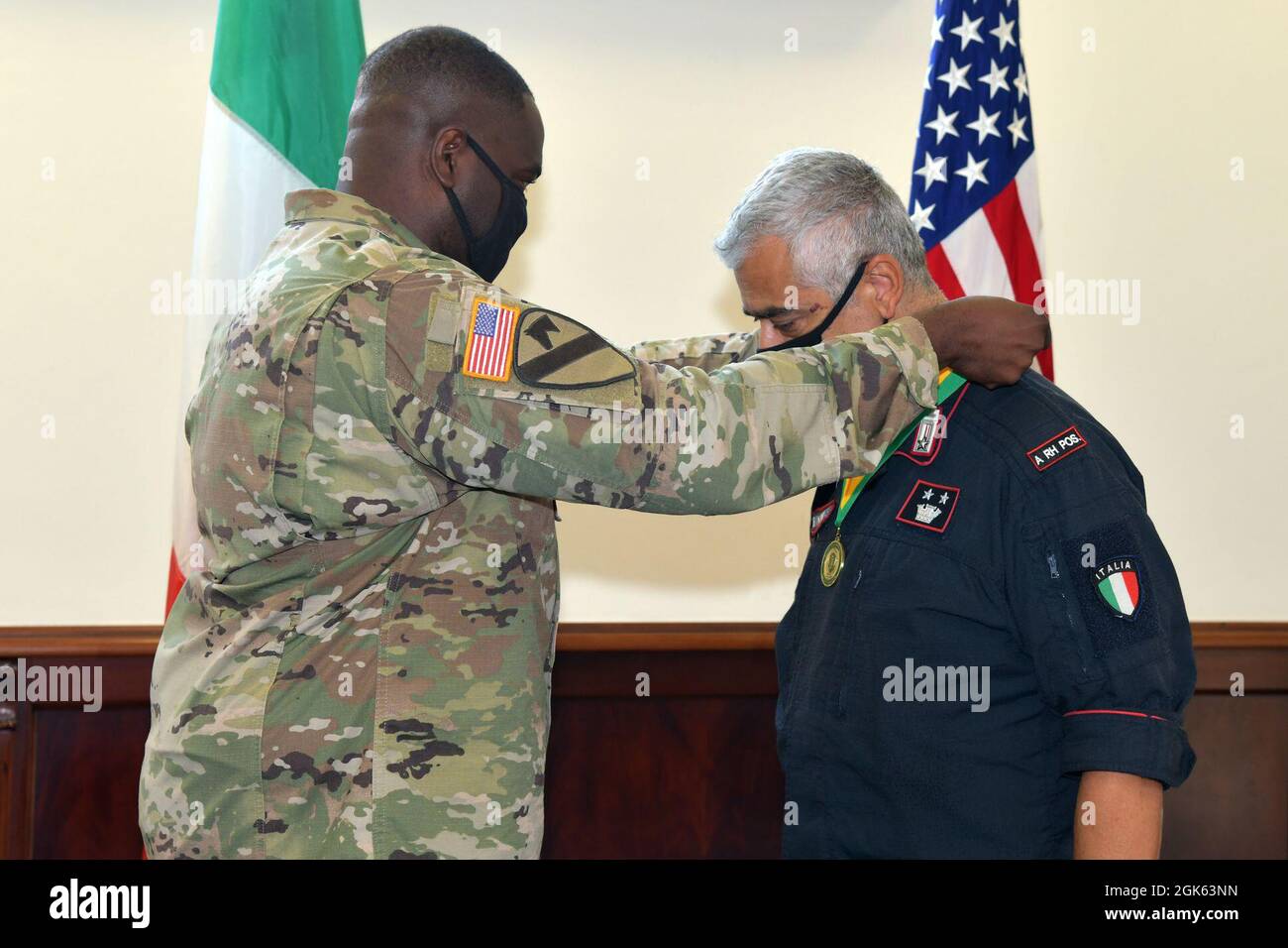 Lt. Col. Francesco Provvidenza, right, Company Commander of the Italian Army Carabinieri South European Task Force receives medal of the Military Police Regiment Association for the Friend of the Regiment Award from U.S. Army Lt. Col. Vaughan M. Byrum, Director of Emergency Services U.S. Army Garrison Italy, under Covid-19 prevention condition at Caserma Ederle, Vicenza, Italy August 12, 2021. Stock Photo
