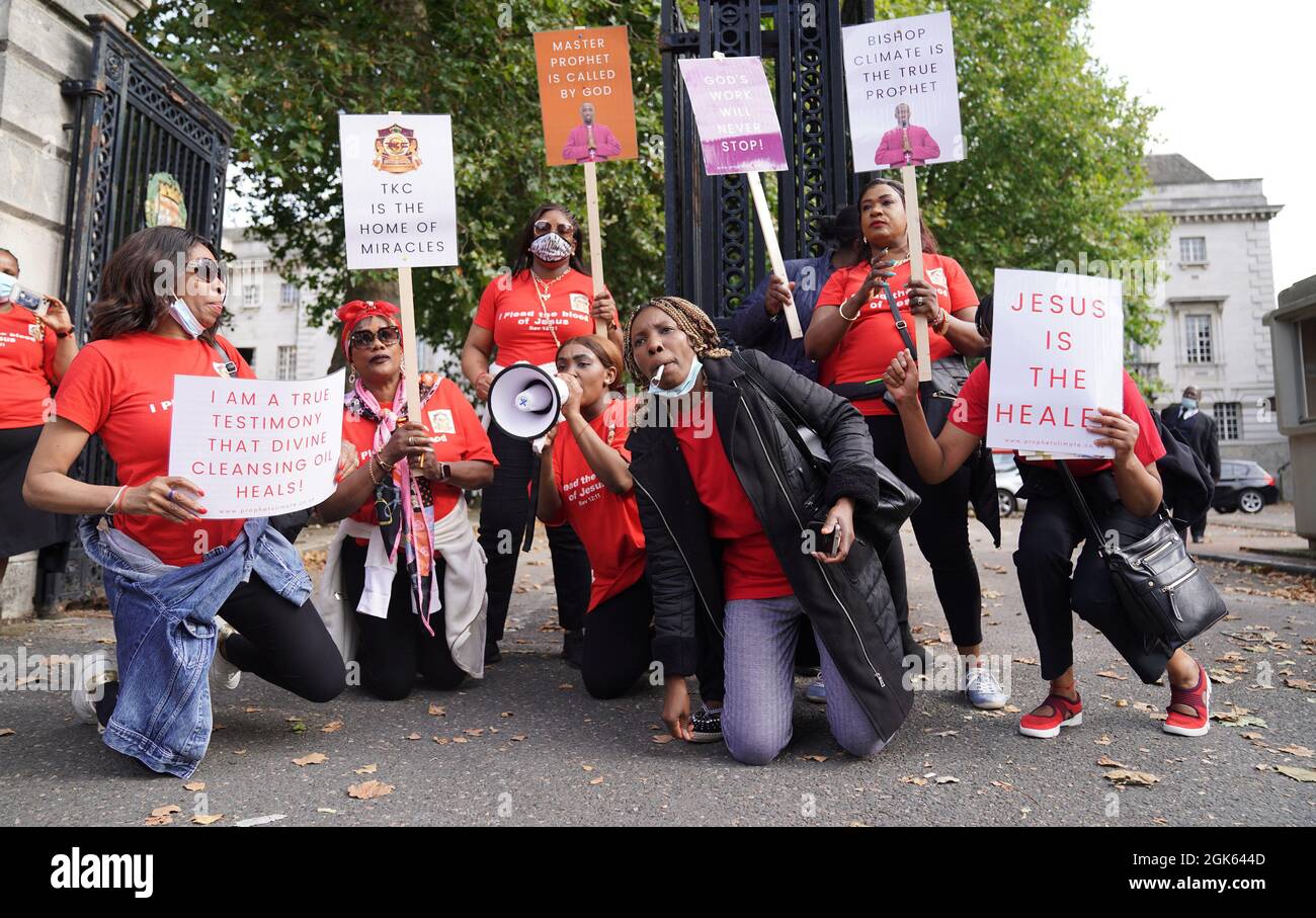 Supporters outside Inner London Crown Court, where Climate Wiseman, 46, is charged with fraud and unfair trading offences over the selling of 'plague protection kits' with claims a mixture made from oil and red string, was a cure for Covid-19. Picture date: Monday September 13, 2021. Stock Photo