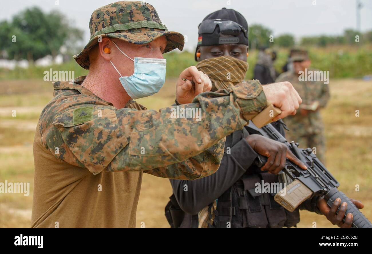 A U.S. Marine with Combined Task Force-68 instructs a member of the ...