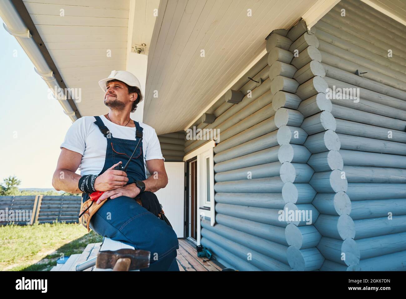 Resting On Railing Builder resting on porch railing after finishing work Stock Photo - Alamy