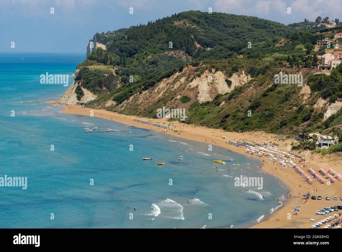 Picture postcard images of Agios Stefanos in Corfu incorporating sunny seascape view containing sea beaches rocks tourists tourism travel and holidays Stock Photo