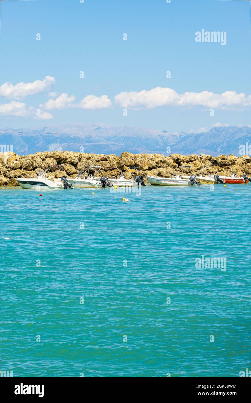 Picture postcard images of Agios Stefanos in Corfu incorporating sunny seascape view containing sea beaches rocks tourists tourism travel and holidays Stock Photo
