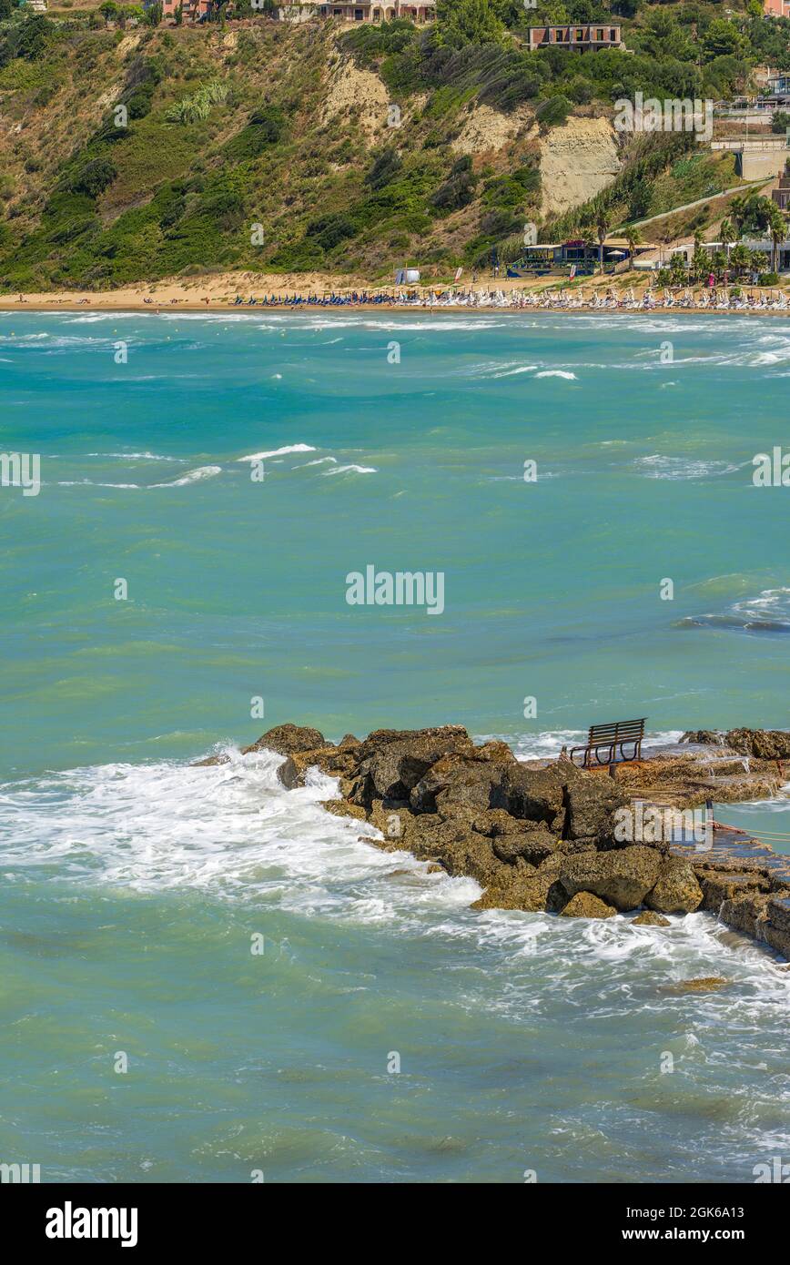 Picture postcard images of Agios Stefanos in Corfu incorporating sunny seascape view containing sea beaches rocks tourists tourism travel and holidays Stock Photo