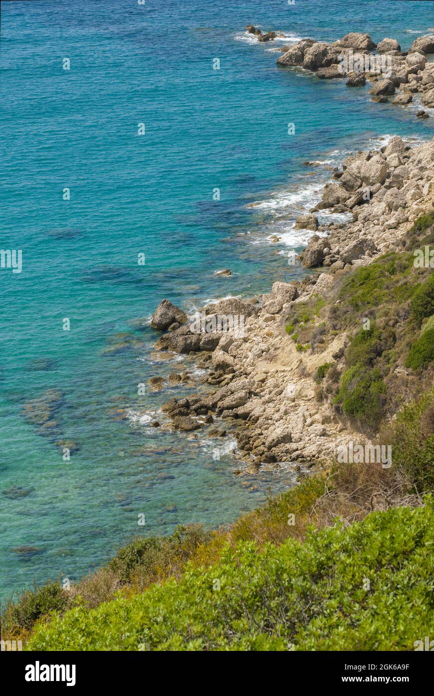 Picture postcard images of Agios Stefanos in Corfu incorporating sunny seascape view containing sea beaches rocks tourists tourism travel and holidays Stock Photo