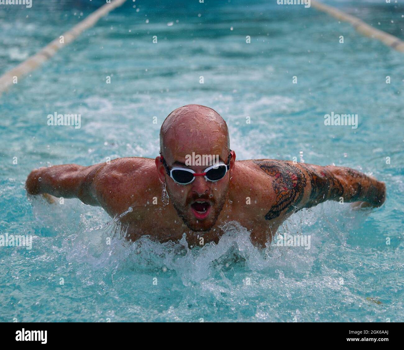 DIEGO GARCIA, British Indian Ocean Territory (Aug. 13, 2021) – A U.S. Navy Diver participates in a swimming relay race during Captain’s Cup onboard U.S. Navy Support Facility Diego Garcia Aug. 13, 2021. Captain’s Cup is a series of events hosted by a selected department or the previous winner. Each event is created to challenge the other departments and determines who the next Captain’s Cup champion is. Stock Photo