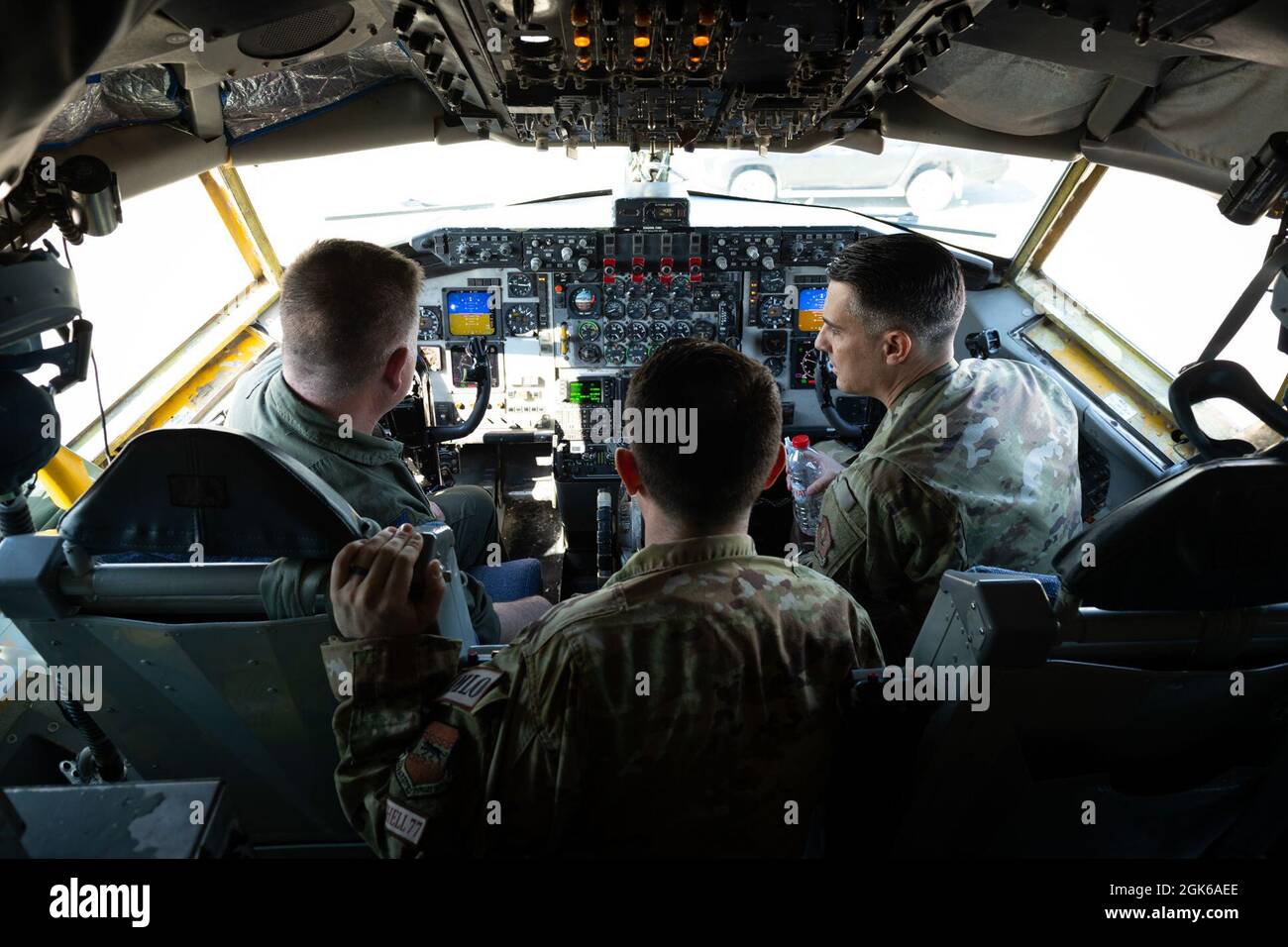 Maj. Frank Simon (center), 93rd Expeditionary Air Refueling Squadron director of operations, showcases the cockpit of a KC-135 Stratotanker to Col. Jason Gingrich (left), 39th Air Base Wing commander, and Chief Master Sgt. Scott Shrier, 39th ABW command chief, during an immersion tour of the 93rd EARS at Incirlik Air Base, Turkey, Aug. 13, 2021. The command team’s visit was part of a series of immersion tours to demonstrate how each unit supports the 39th ABW and U.S. Air Forces in Europe-Air Forces Africa. The 93rd EARS delivers aerial refueling capabilities to allies and coalition partners, Stock Photo